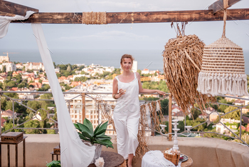 Young fashion woman in white jumpsuit with styling, holding glass of white wine / Photodune, Misc
