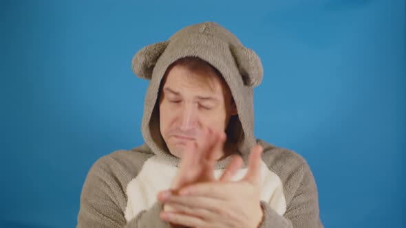 Man in Hoodie with Ears n Applauding with His Hands on Blue Background