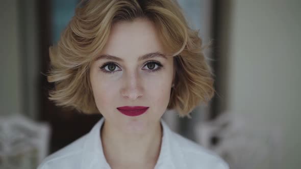 Close Portrait of Woman Opening Eyes and Looking at Camera