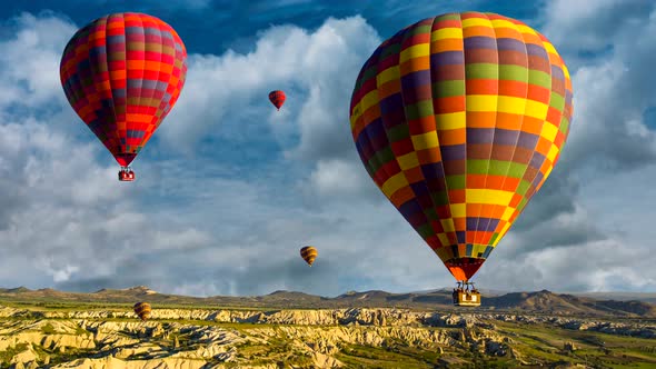 Cinemagraph with parallax effect of hot air balloons rising over the Cappadocia, Turkey desert amids