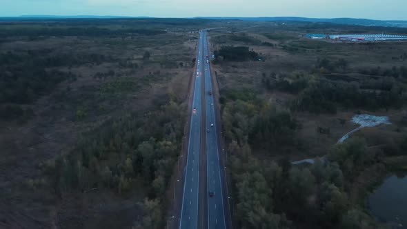 Drone aerial shot of a road passing through rural scene.