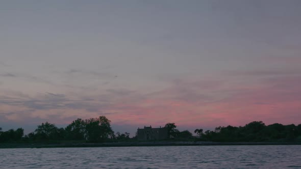 Hart Island, Solemn burial site for unidentified dead, from the water, sunset in the evening.