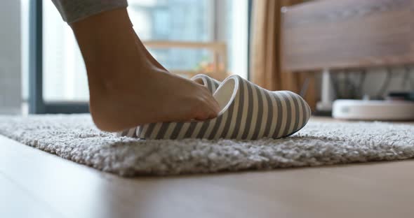 Woman wear fleece slippers at home