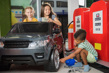 Little auto mechanic repairing toy car in playroom. / Photodune, Misc