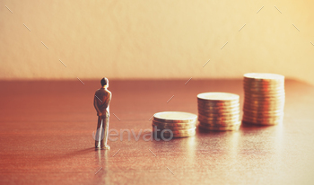 Miniature people looking future with stack coin about financial and money savings concept. / Photodune, Misc