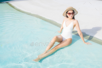 Portrait beautiful young asian woman relax smile around outdoor swimming pool / Photodune, Misc