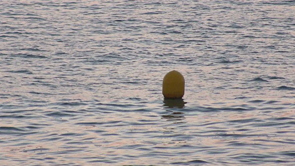 Yellow Buoy Bobs on the Waves