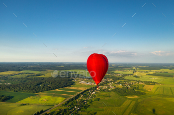 Red heart-shaped balloon with people over green fields and forests / Photodune, Misc