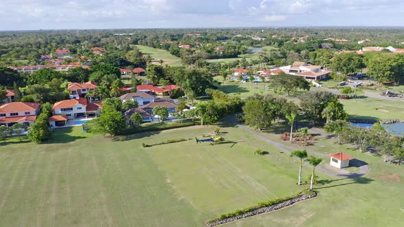 Aerial view of scenic Metro Country Club Hotel during sunny day with lawn,terrace,pool and private l