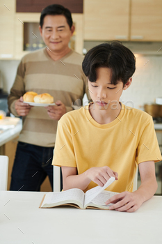 Proud Father Looking at Reading Son / Photodune, Misc