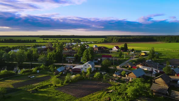 Drone view of village at sunset. Fantastic sky with blue clouds look cinematic