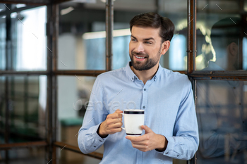 Young bearded man in a blue shirt smiling and feeling relaxed / Photodune, Misc