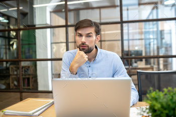 Bearded man in a blue shirt looking thoughtful / Photodune, Misc