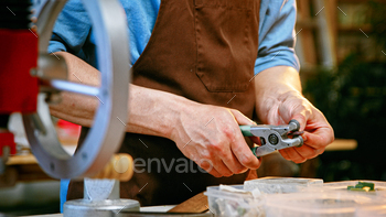 Working man in apron with cutter / Photodune, Misc