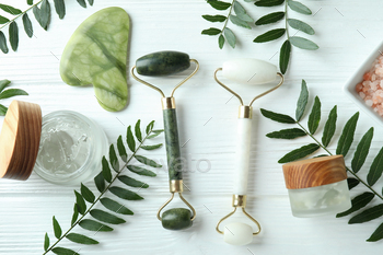 Skin care concept with face rollers on white wooden background / Photodune, Misc