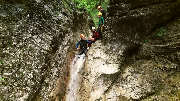 Aerial view of man throwing himself through a sliding rock at Soca river.