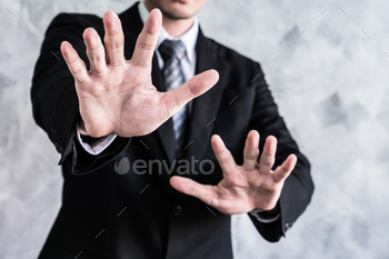 Close up of businessman showing palm handsign on grunge background. / Photodune, Misc