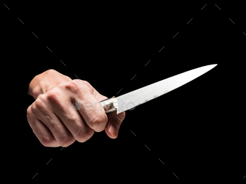 Male hand holding knife on black background. / Photodune, Misc