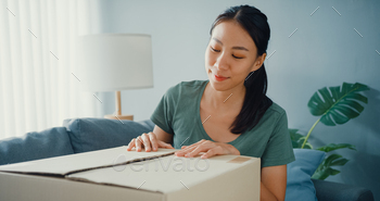 Happy asia lady open cardboard box package exciting and enjoy trying and matching. / Photodune, Misc