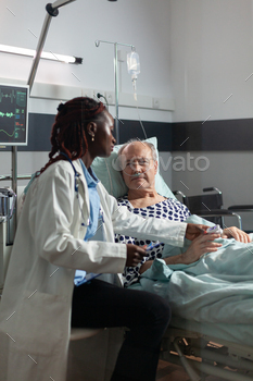 Unwell senior patient laying in bed breathing through oxygen test tube / Photodune, Misc
