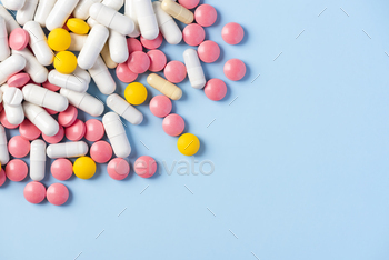 Colorful Tablets Pills and Medicine Capsules Scattererd on Background / Photodune, Misc