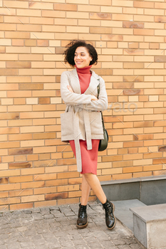Beautiful african american businesswoman with an afro hairstyle. Mixed race girl walking. / Photodune, Misc