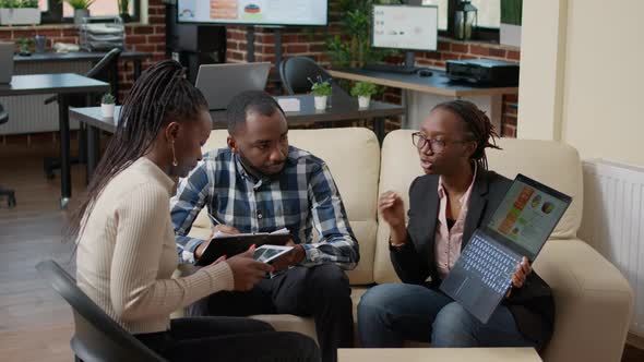 African American People Planning Sales Report on Laptop