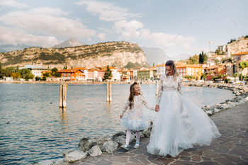 Italy, Lake Garda.Stylish Mother and daughter on the shores of lake Garda in Italy at the foot of / Photodune, Misc