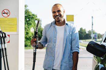 Man filling gasoline fuel in car at gas station / Photodune, Misc