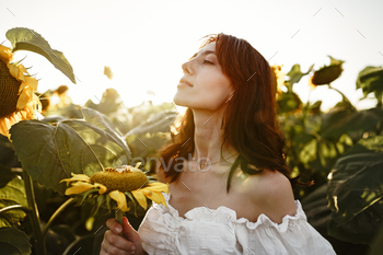 Portrait of beautiful young woman in a field of sunflowers / Photodune, Misc