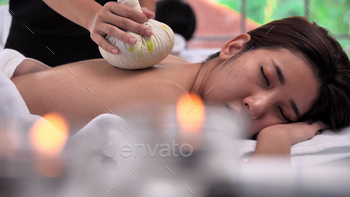 Young Asian woman getting relaxing during therapist put herbal spa ball / Photodune, Misc