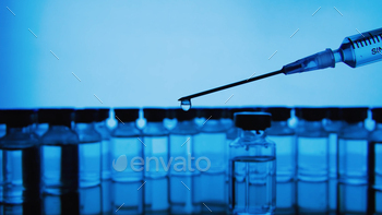 Vaccine bottles and syringe injection. Medicine in ampoules. / Photodune, Misc