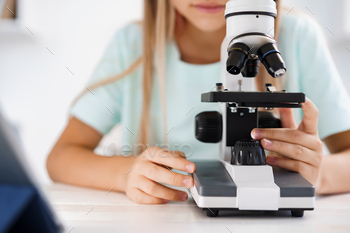 Close up photo of little girl using microscope / Photodune, Misc
