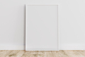 Empty thin white frame on light wooden floor with white wall behind it. - PhotoDune Item for Sale