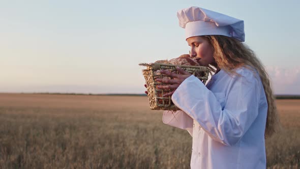 Handsome Baker Woman Smelling the Fresh Bread From