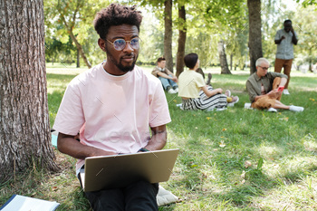 Man working on laptop outdoors / Photodune, Misc