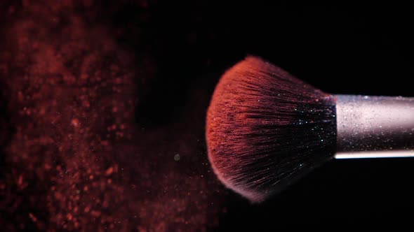 Make Up Brush with Colored Red Powder at Black Background Slow Motion