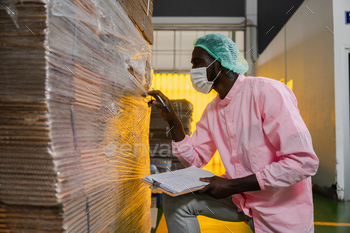 African American man distribution a box package in shipping factory warehouse / Photodune, Misc