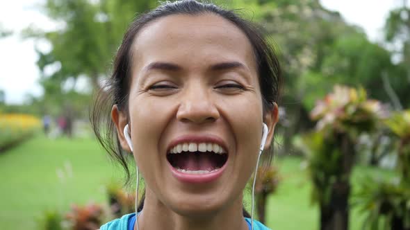 Attractive pretty woman laughing with wildly delighted with something.