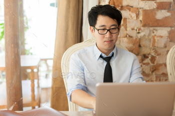 Casual businessman working while looking boring in outdoor office / Photodune, Misc