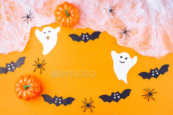 Halloween frame with web, spiders, ghosts, bats and pumpkin on orange paper / Photodune, Misc