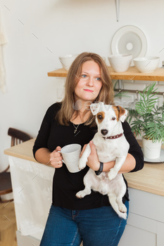 Happy female owner of jack russell terrier dog, feels responsibility of caring about pet, standing / Photodune, Misc