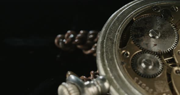 Macro shot of an antique pocket watch on a dark background