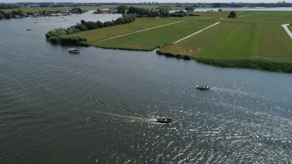 Aerial Slomo panning around Small Boat with 5 Male Friends Sailing surrounded by other boats Dutch C