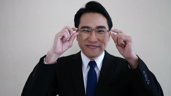 businessman facing camera. wearing glasses.