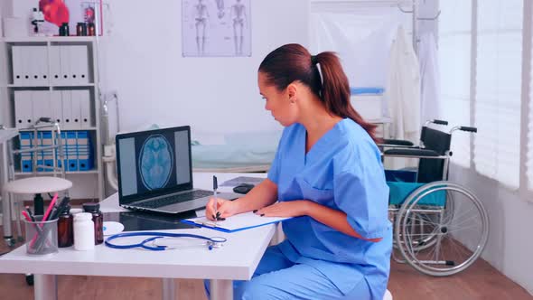 Group of Assistents Working in Hospital Office Analysing Digital Brain Radiography