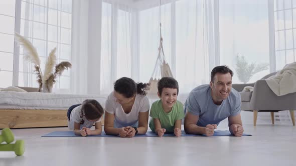 Active Family Keeping Plank During Yoga Exercises