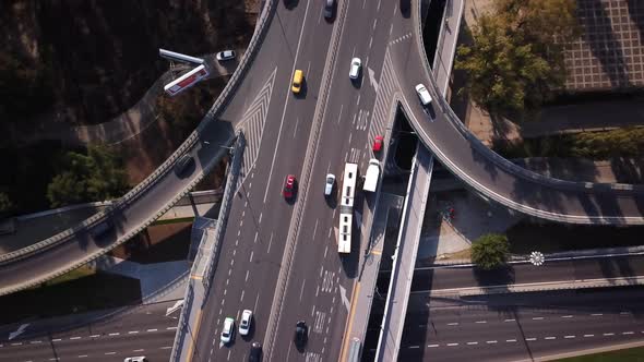 Aerial shot focuses on Bus crossing the bridge, traffic on the bridge. Cars driving. 4K. Crossroads