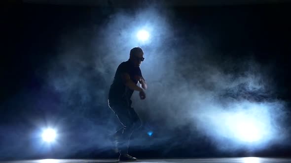 One Hip Hop Break-dancer Stylish Man in Sunglasses Starts Dancing, Smoke, Silhouette, Slow Motion