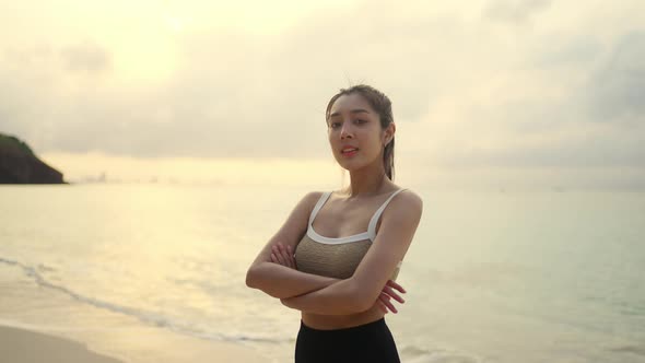 4K Portrait of Asian woman jogging exercise on tropical island beach in summer morning.